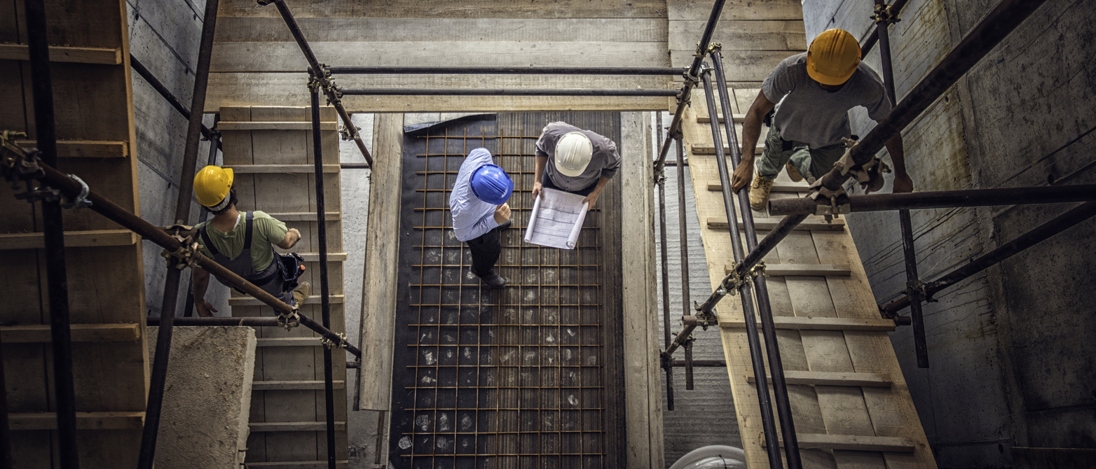 Construction workers and architects viewed from above